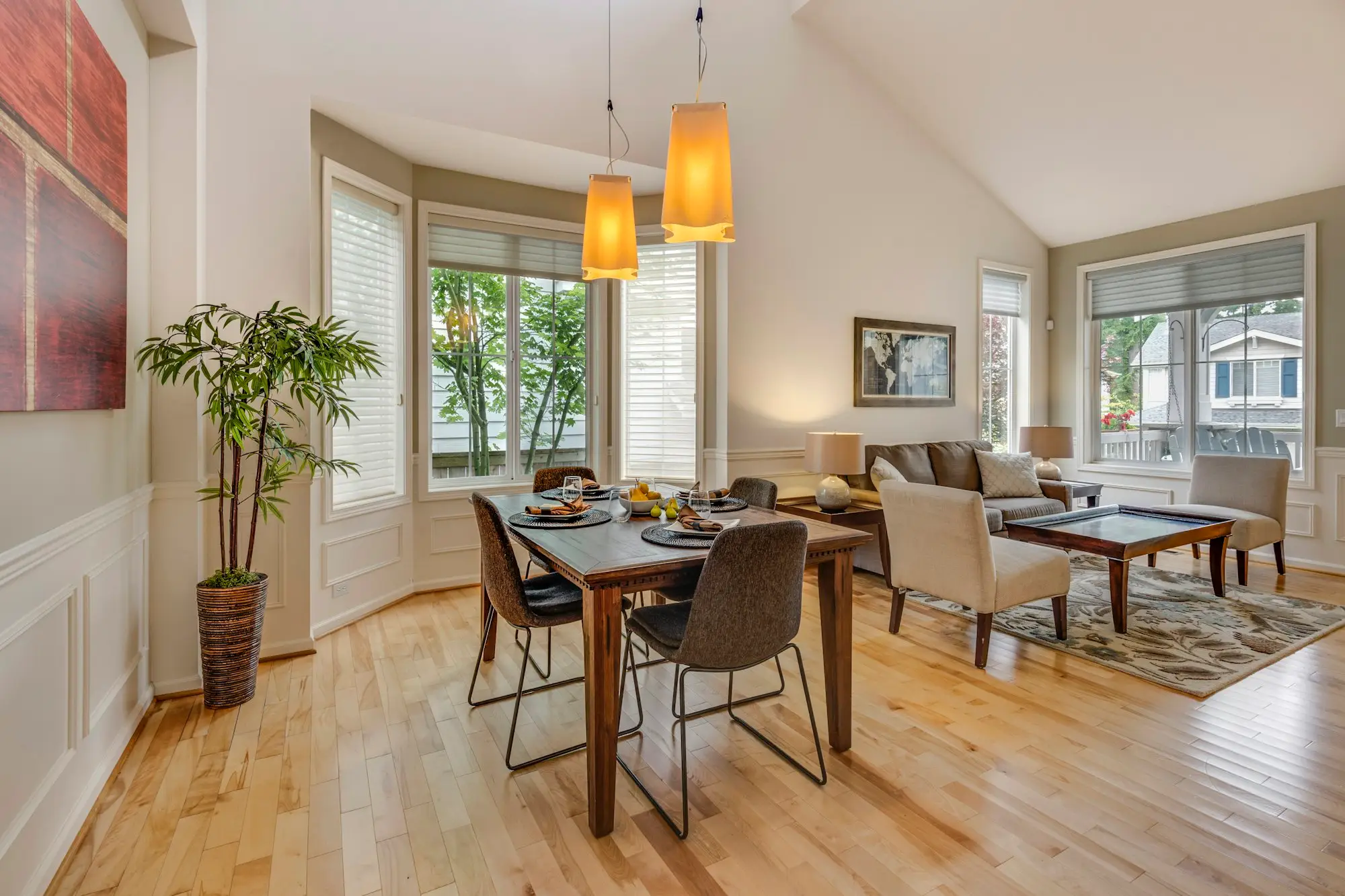 Wood dining table and chairs beside a window