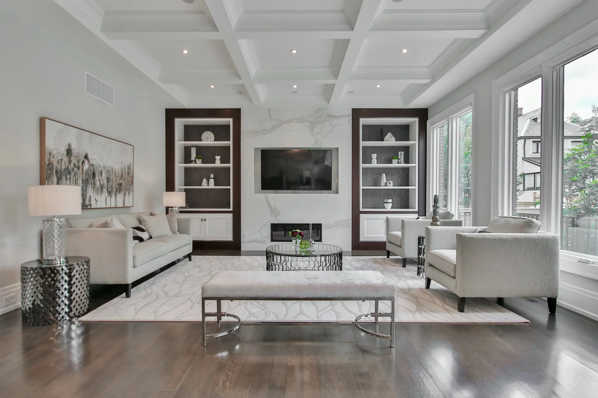 Living room with a marble fireplace and pale sofas