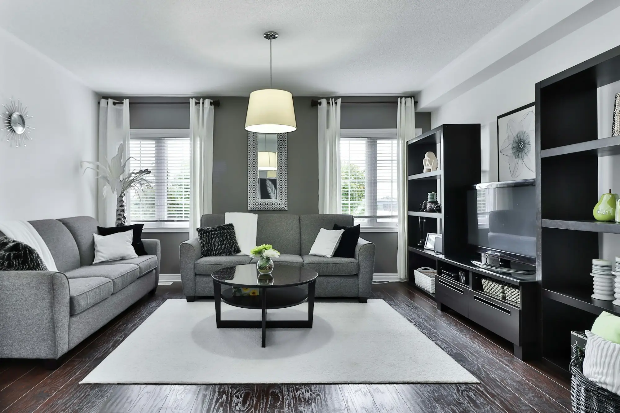 A quieter living room in gray upholstery and wood