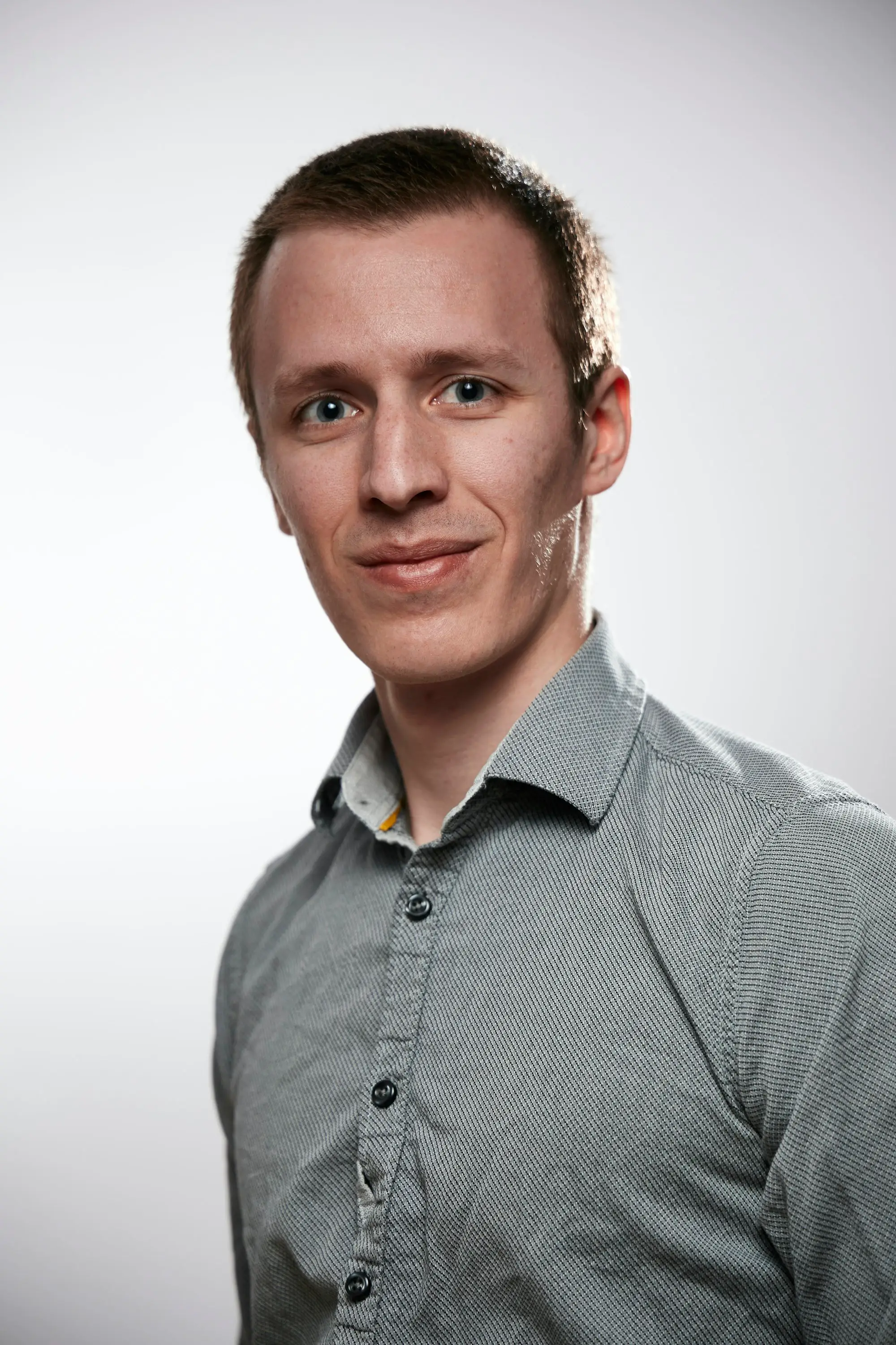 Portrait of Chris Dalton, a man in a gray button-up shirt outdoors